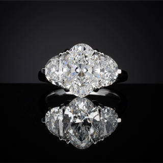 Oval and Half-Moon Three-Stone setting design reference in 14K white gold; pictured center diamond is not included