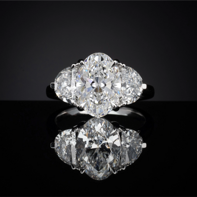 Oval and Half-Moon Three-Stone setting design reference in 14K white gold; pictured center diamond is not included