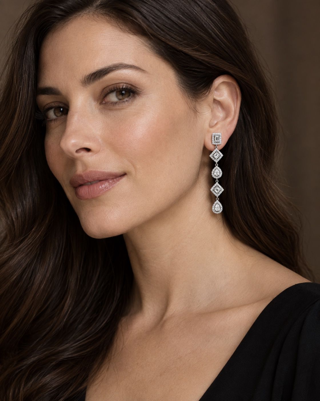 Woman wearing long diamond drop earrings
