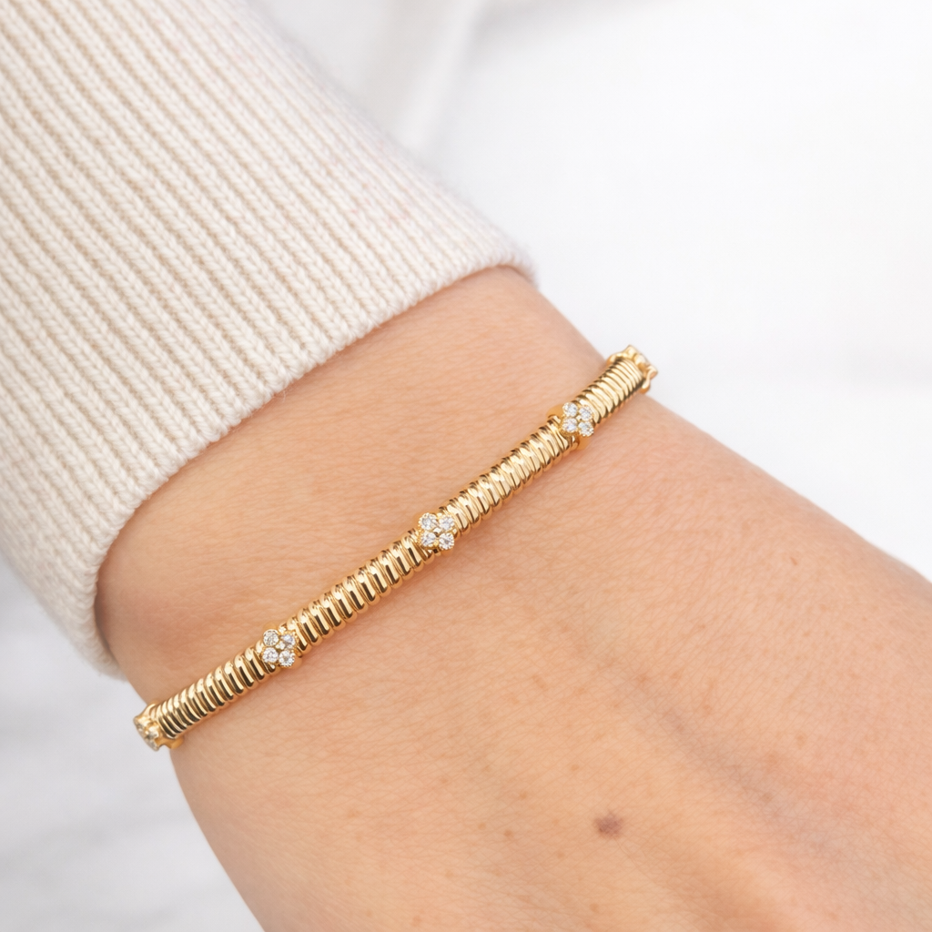 Elegant gold bangle with diamond accents - Laura Milman New York